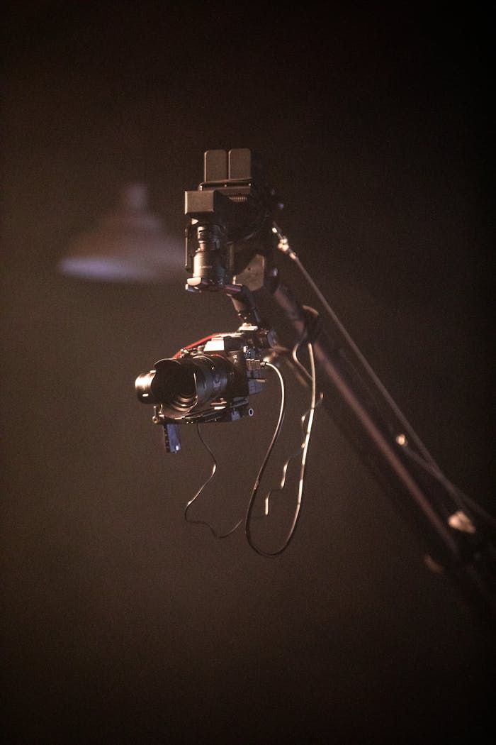 Close-up of a camera on a crane arm used for filmmaking and videography.